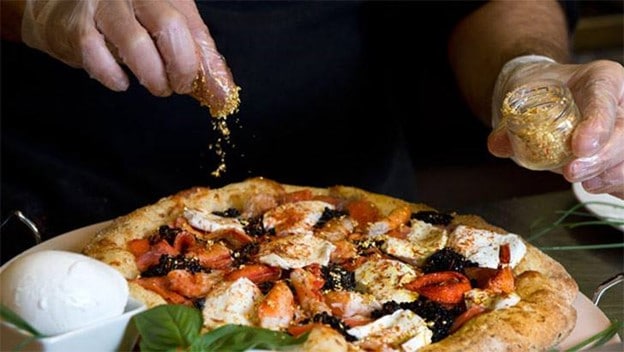 007皇家披萨诞生于2006年，目的是为了庆祝詹姆斯·邦德系列电影的重启，同时也为慈善事业筹集资金。出生于格拉斯哥的厨师Domenico Crolla创造了这款披萨，他的目的是创造有史以来最昂贵的披萨。为了给澳大利亚的弗雷德·霍洛斯基金会(Fred Hollows Foundation)筹集资金，该基金会致力于治疗欠发达国家的可治愈的失明，他构思了这个披萨，并把它放到了eBay上。它以相当于2830美元的价格卖给了一位名叫莫里齐奥·莫雷利的律师。Crolla飞到他在罗马的家中制作了这款007皇家披萨，上面放了很多奢侈的配料，包括用干邑浸泡的龙虾、苏格兰烟熏鲑鱼、可食用黄金、鹿肉和香槟浸泡的鱼子酱。
